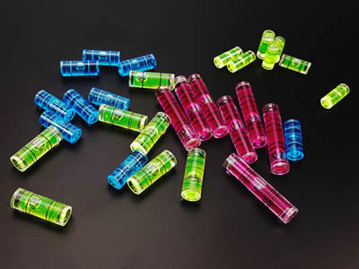 There are several plastic tubular bubble level vials in different color.